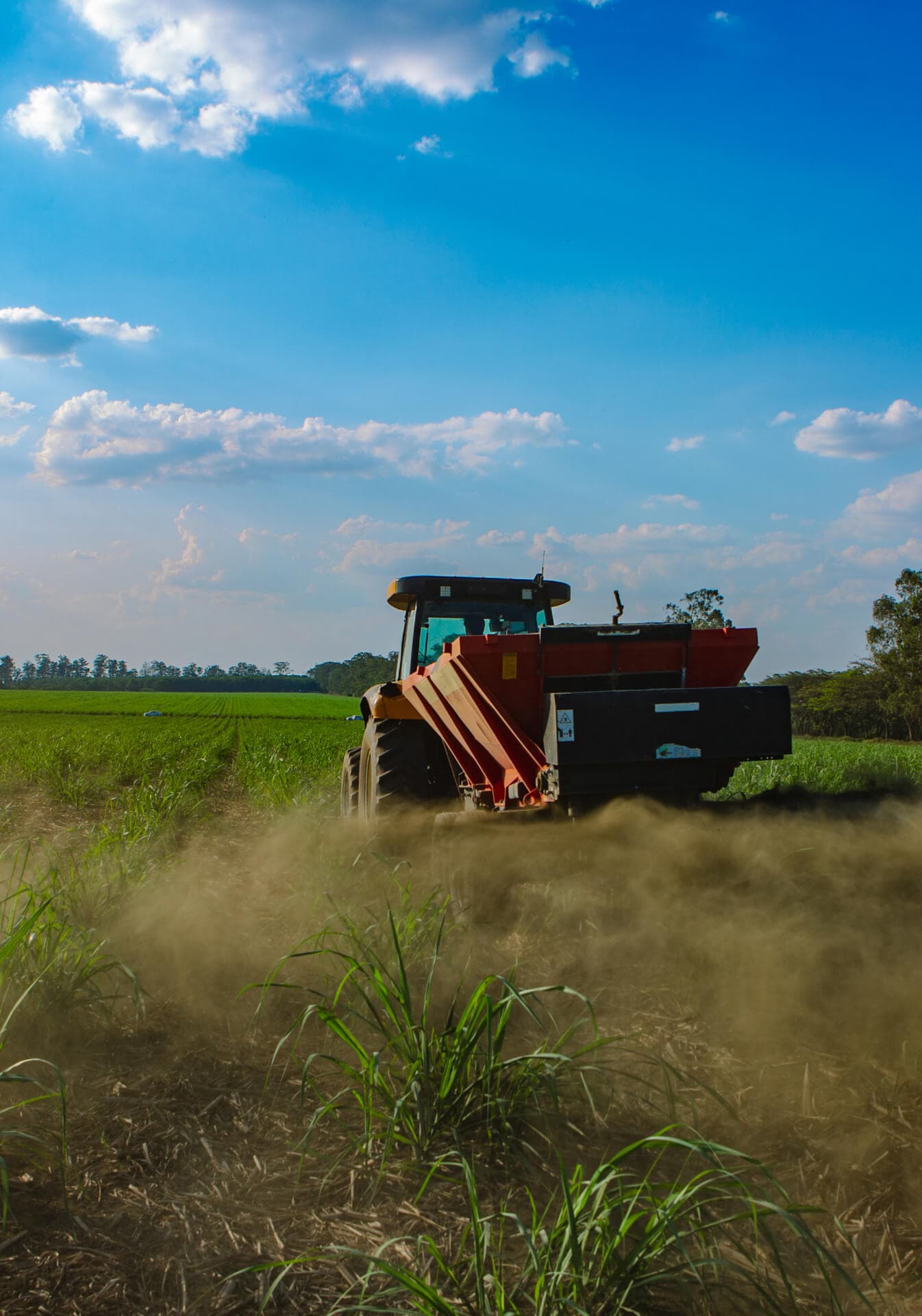A tractor spreading rock powder